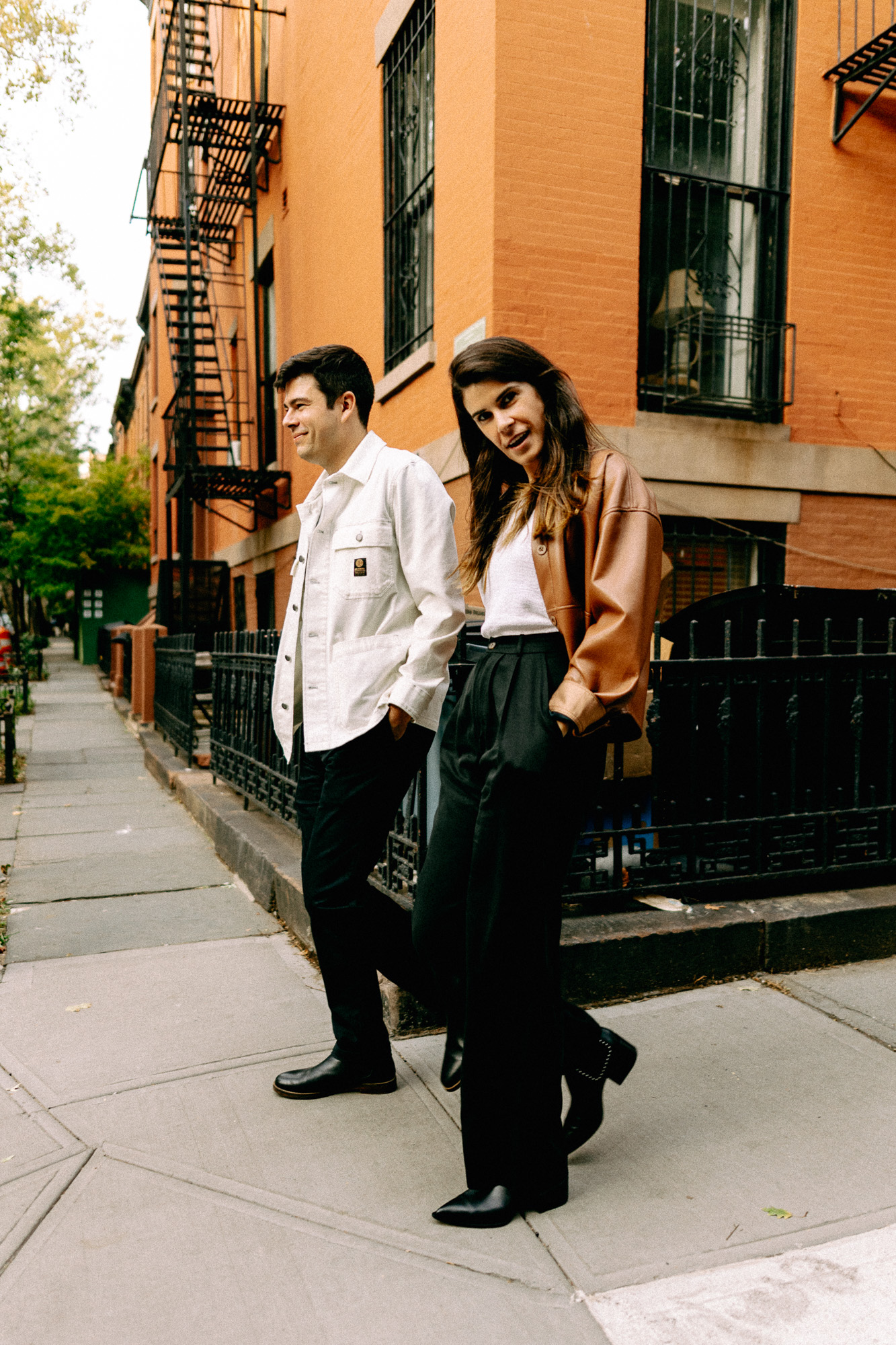 Full-length couple on Brooklyn sidewalk